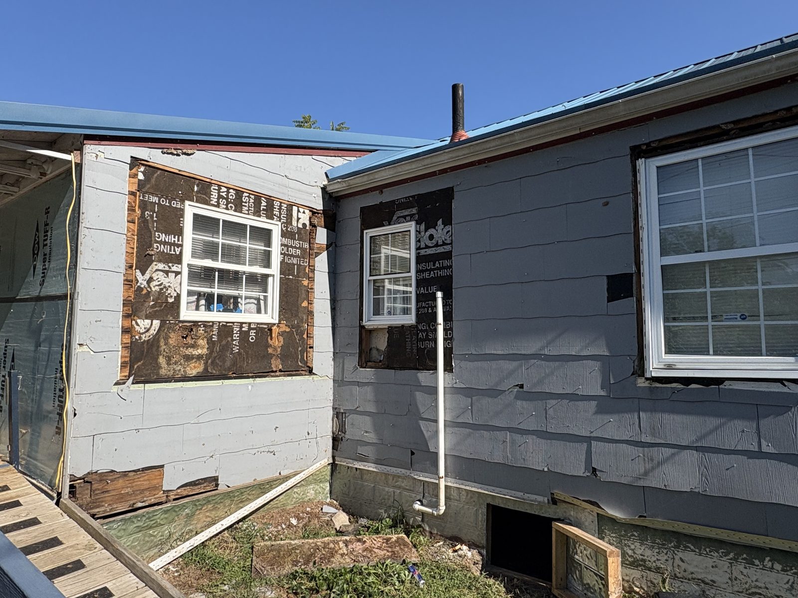 Home with old siding stripped to sheathing